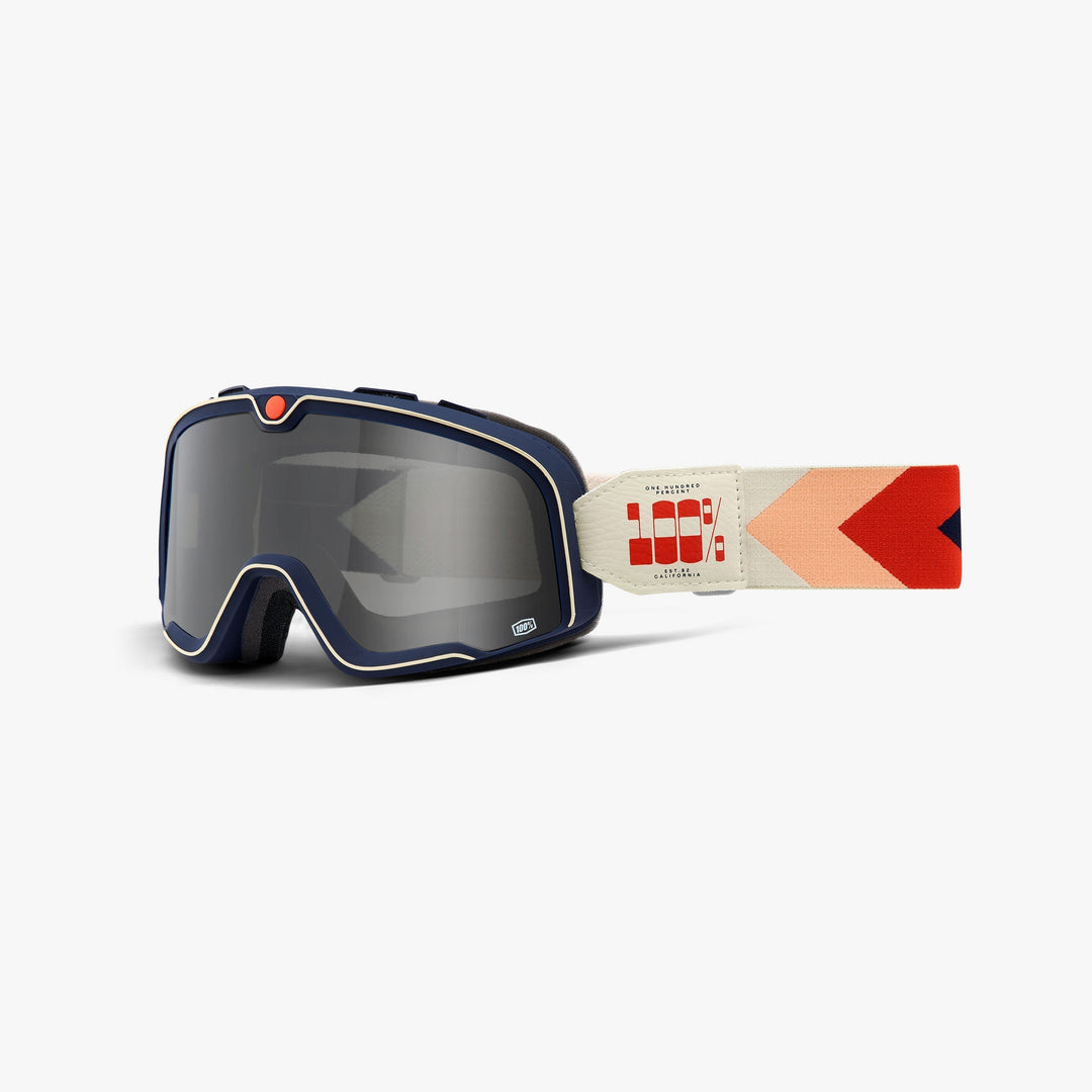 100% Barstow Teluride Brille mit dunkelblauem Rahmen, grau getönter Scheibe und mehrfarbigem Band.